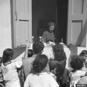 Woman handing out free medicine to people in need. San Juan, Puerto Rico.